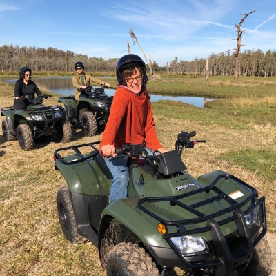 a group of people sitting around a car