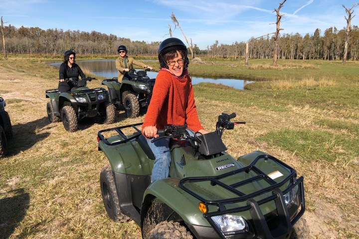 a group of people sitting around a car