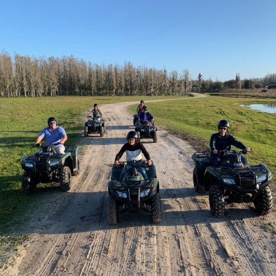 a motorcycle parked on the side of a dirt road